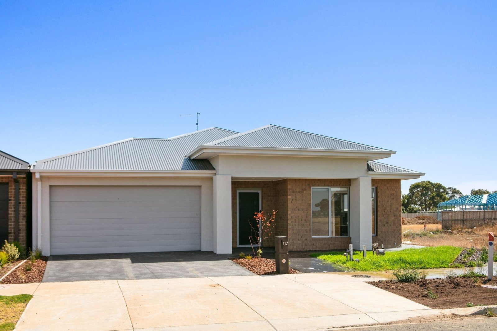 A Necessity Housing home in Armstrong Creek: a single-storey house with a landscaped front garden.