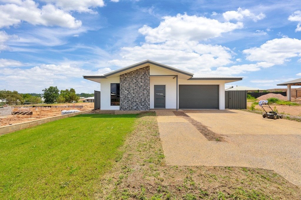 The home from the street, with the driveway and front lawn.