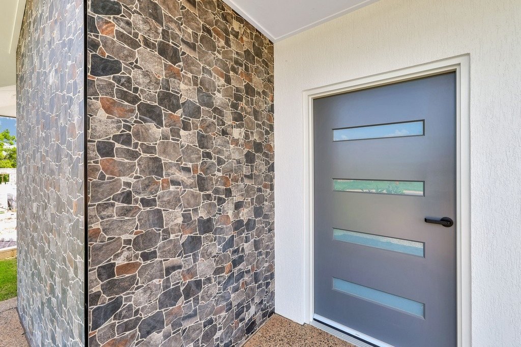 The front door, beside the stone feature wall.