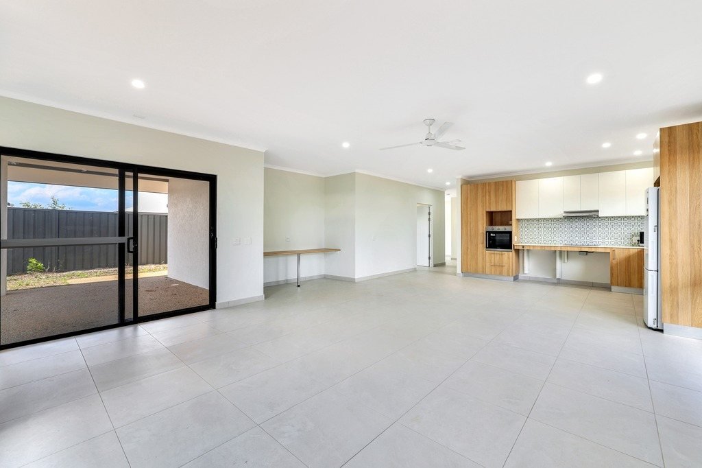 The living and kitchen area, with a sliding door to the verandah.