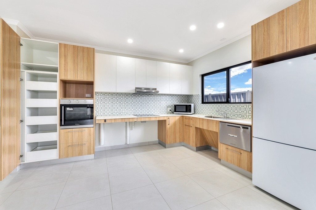 The kitchen, with a pantry and fridge space.