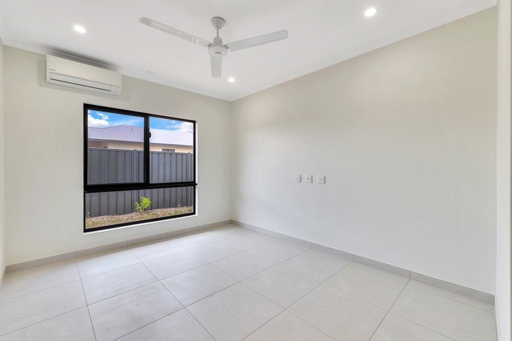 A bedroom with a split-system air conditioner.