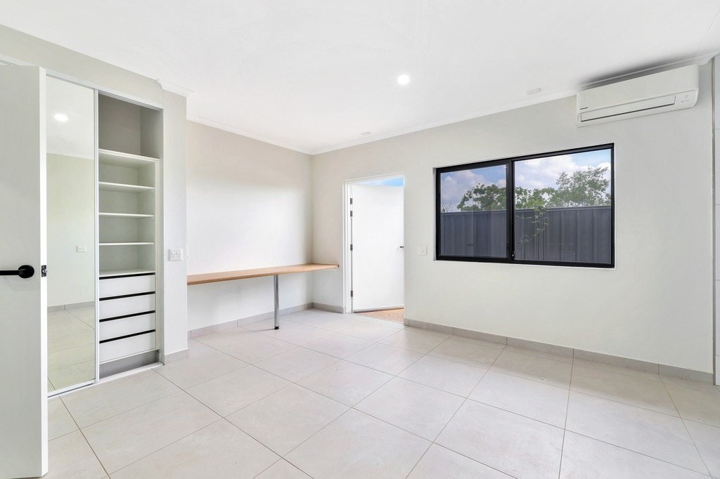 A bedroom with built-in robes.