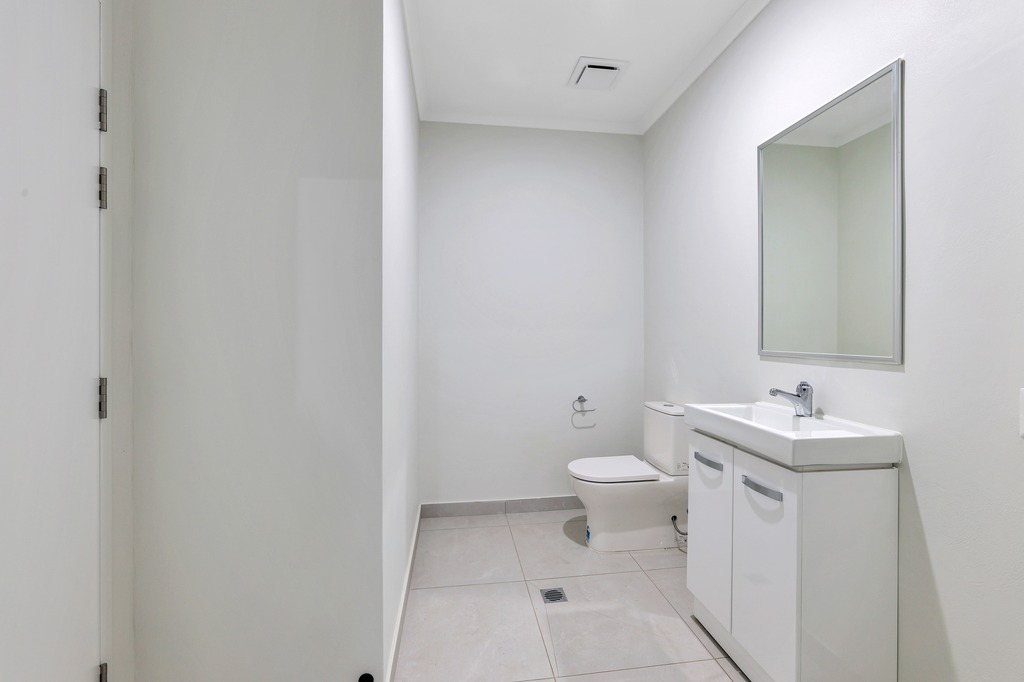 A bathroom with a vanity and toilet.