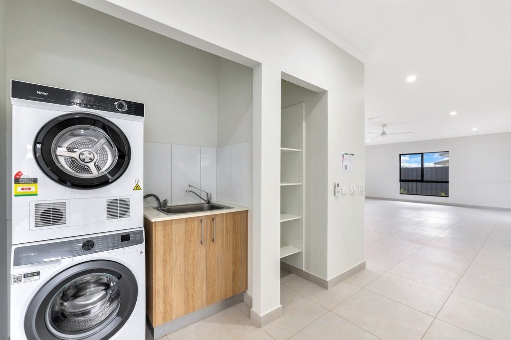 The laundry, with a stacked washer and dryer.