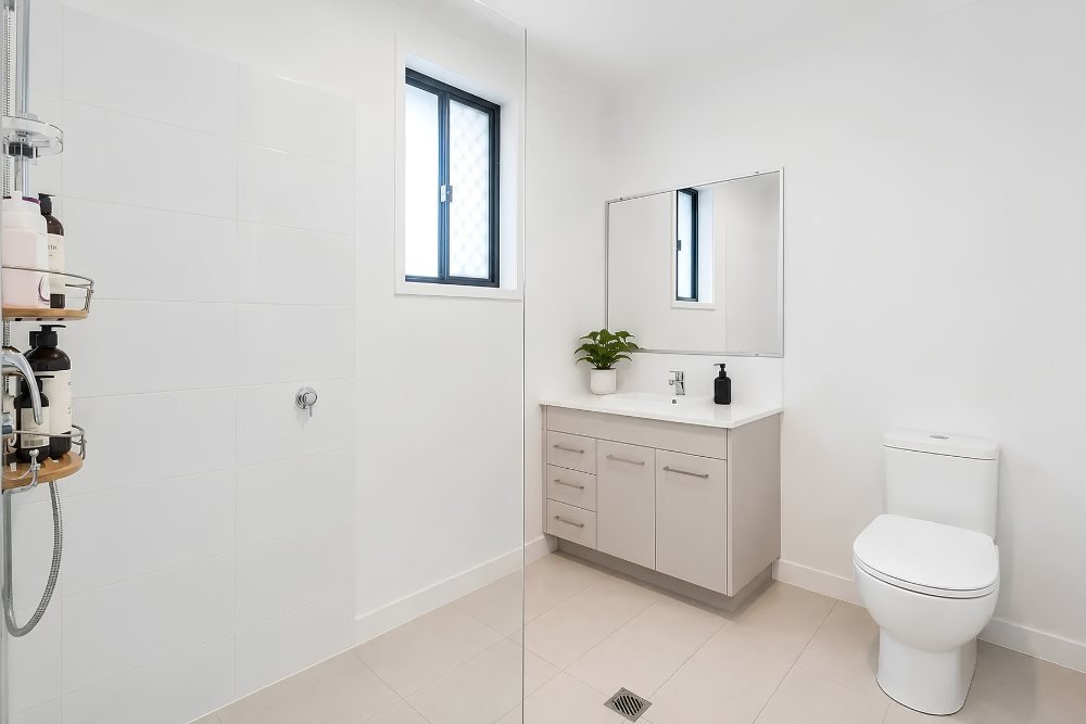 The ensuite, with a step-free shower, vanity and toilet.