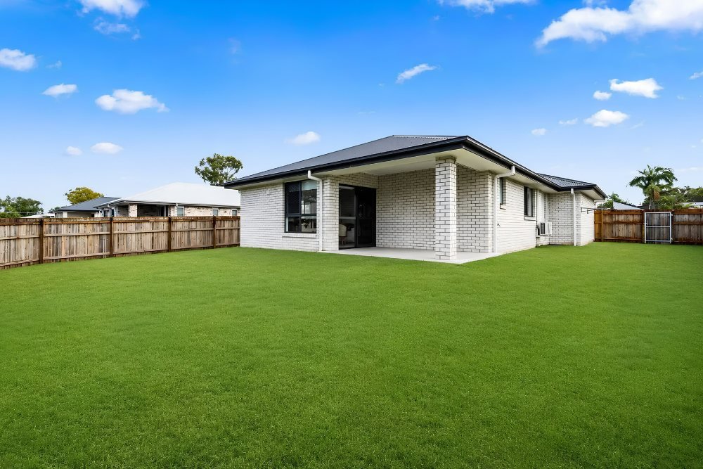 The back of the home and the lawn.