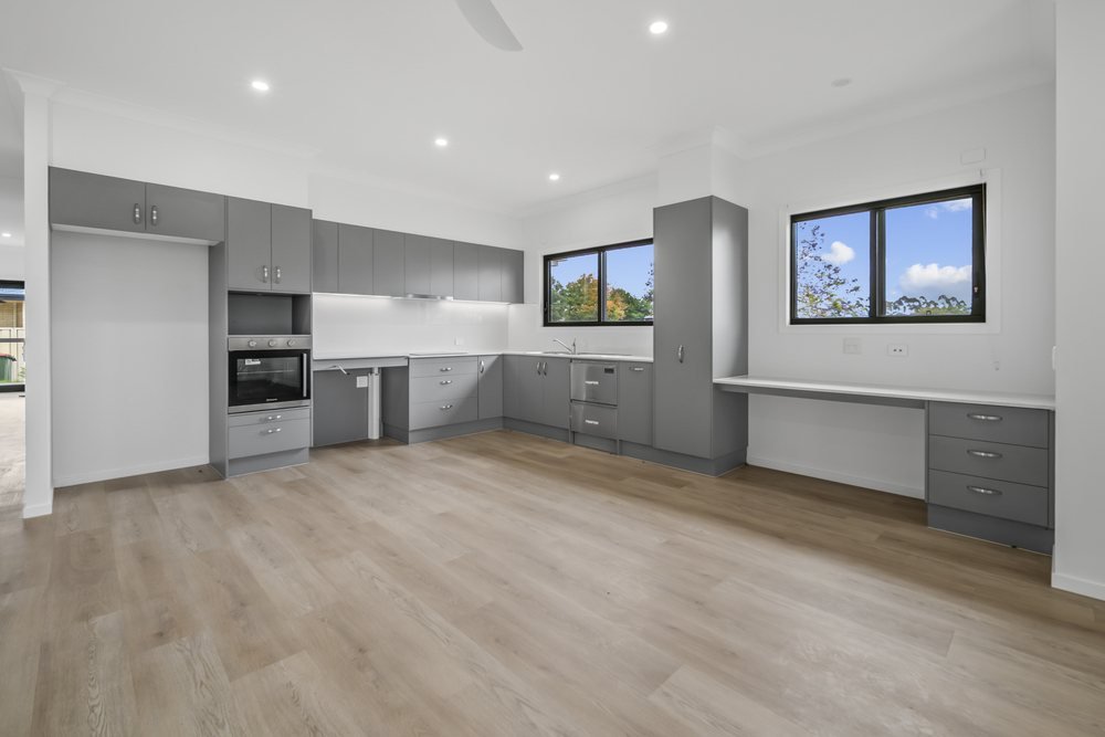 The family room, with a sliding door to the alfresco and the kitchen to the side.