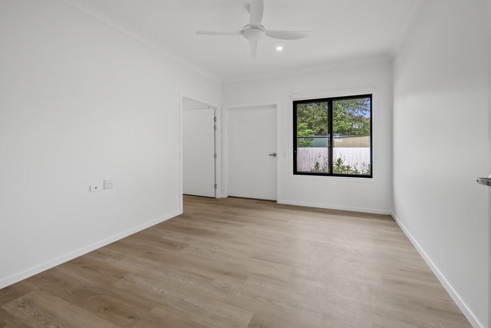 The kitchen, with a wall oven, tall pantry cupboards and a bench with knee space.