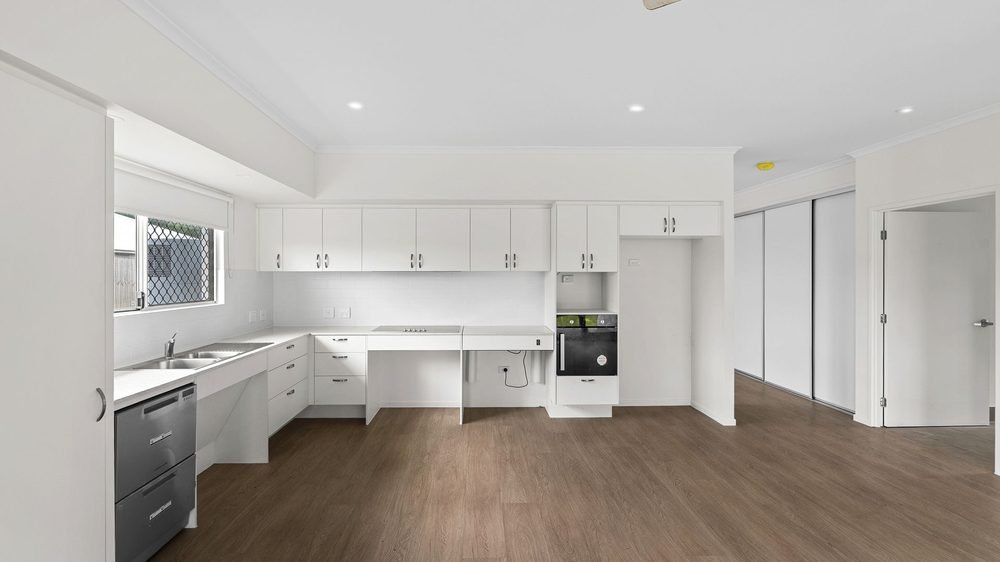 The kitchen, with a wide clear floor space in front of the benches.
