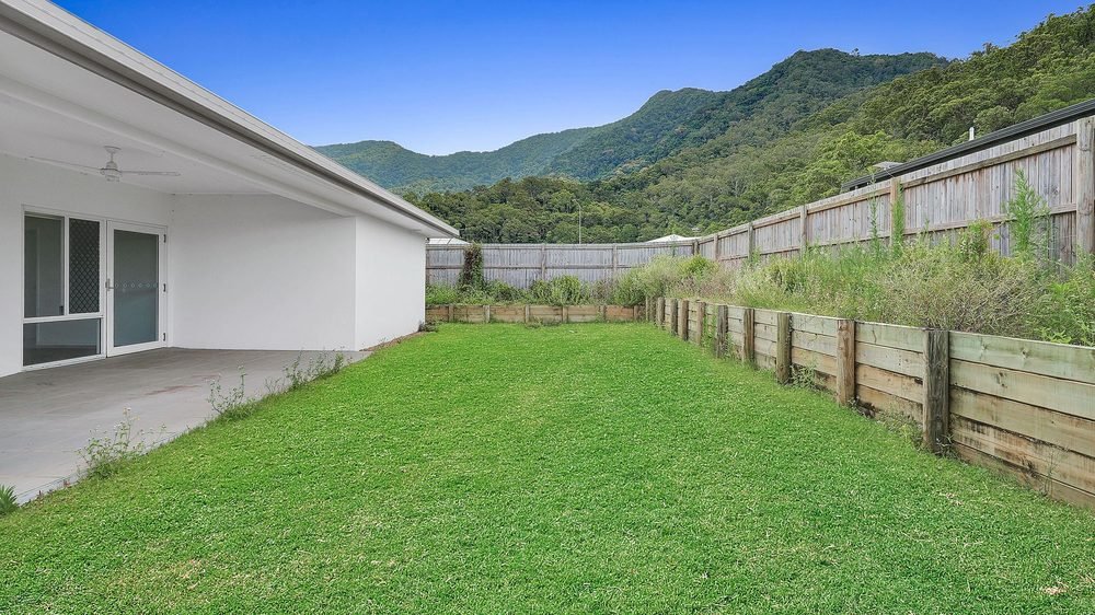 The backyard lawn beside the home.